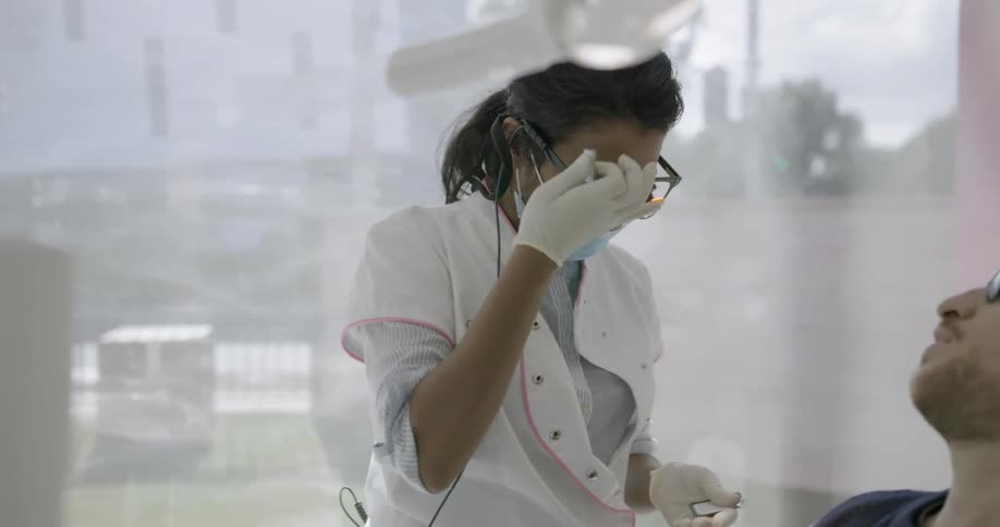 A dentist gets ready to work on a patient