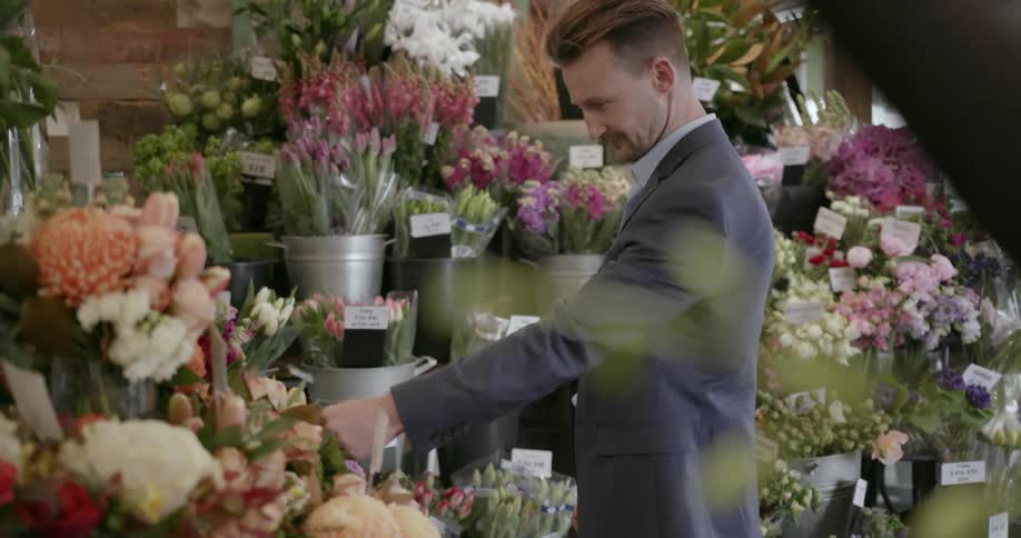 A man shops for flowers in a florist shop