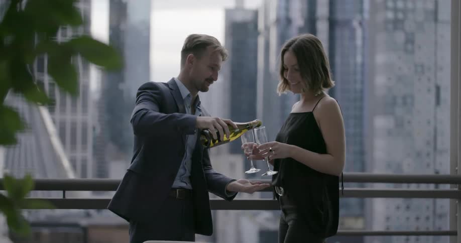 A man pours a woman a glass of champagne