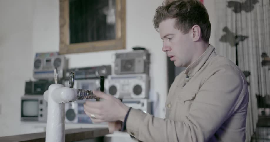 A man puts handles on a tap