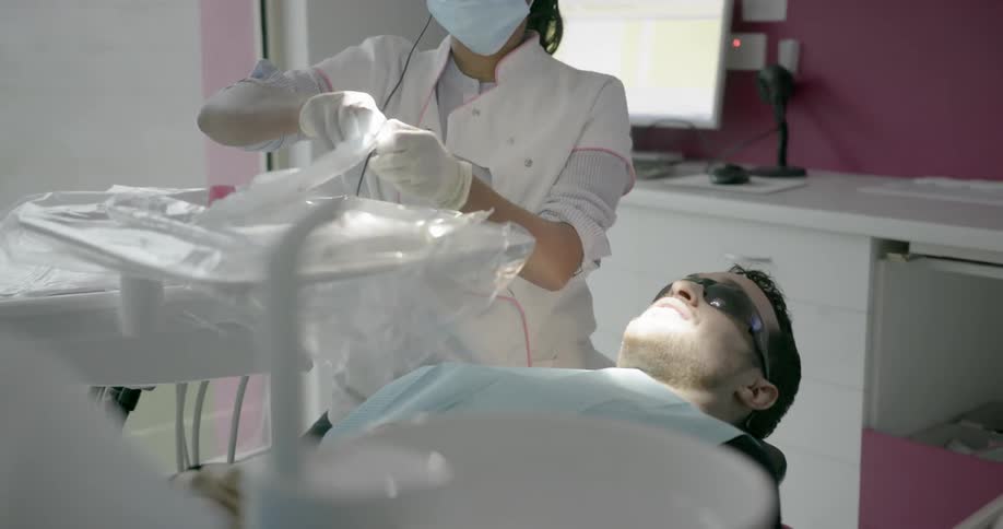 A dentist works on a patient