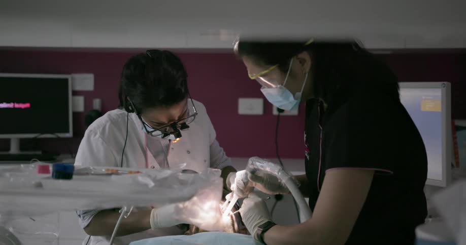 A dentist and dental assistant working on patients teeth