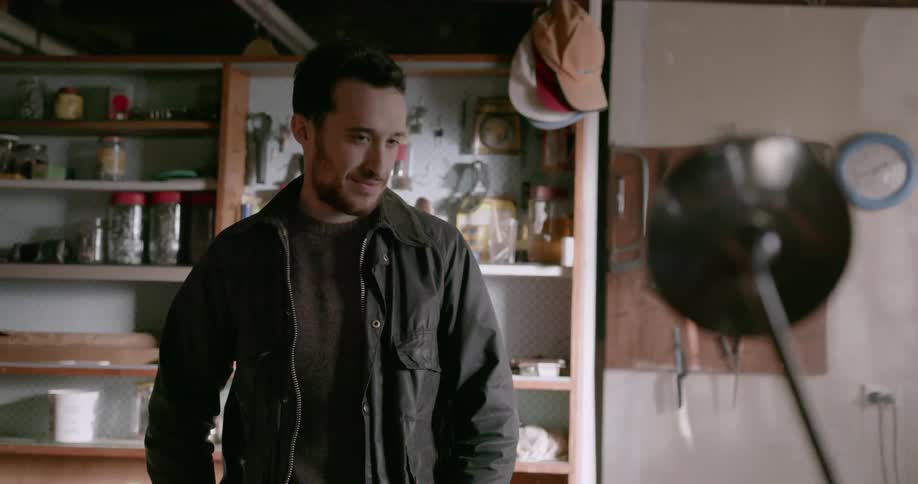 A man nods his head approvingly in his garage