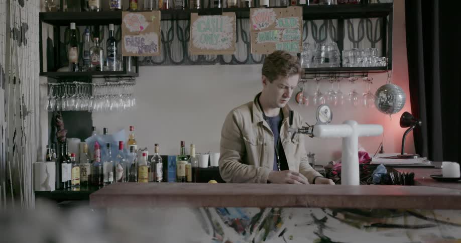 Man puts new taps on a beer dispenser in a bar