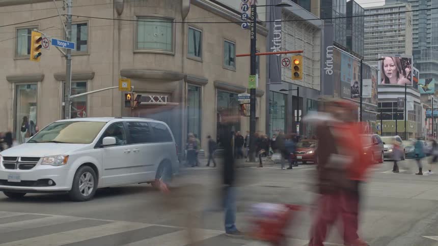 A timelapse video of city traffic and pedestrians at a busy intersection