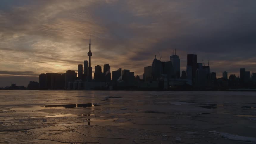 Time lapse of a city in the distance with clouds moving fast