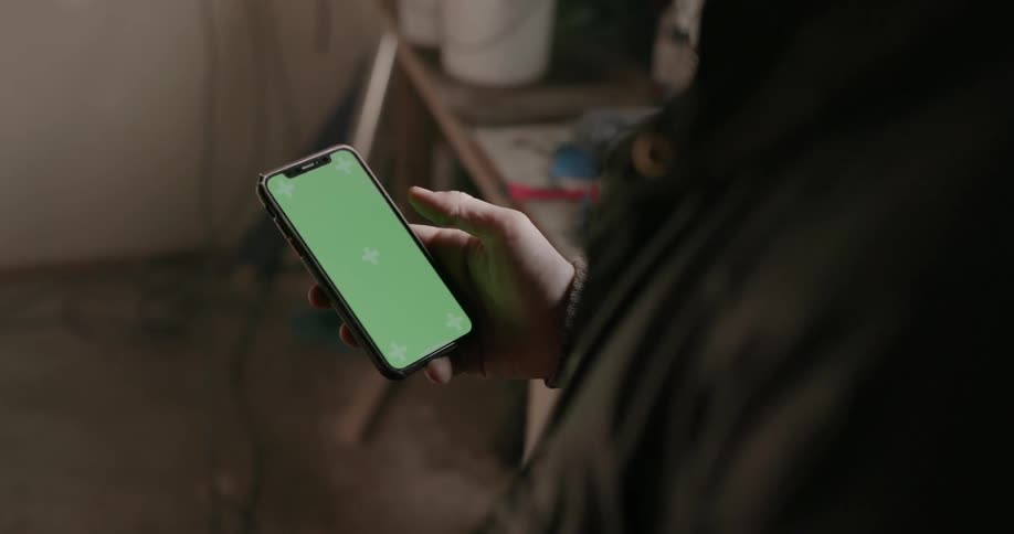 A man scrolls on his cell phone