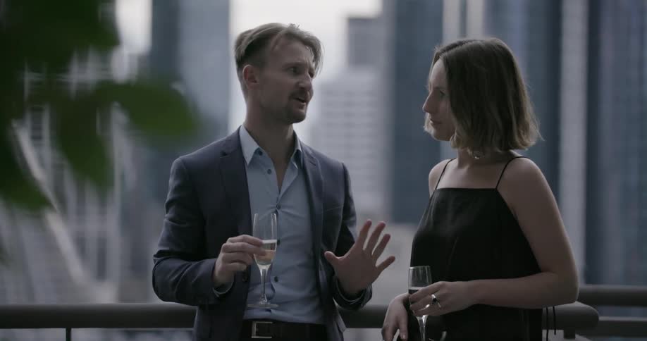 A man and woman talk and have drinks