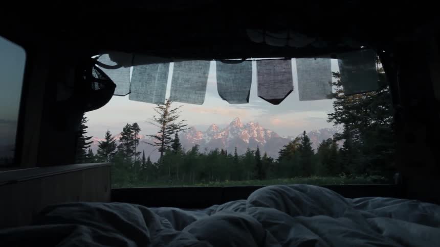 Towels hang on a clothesline outside a tent