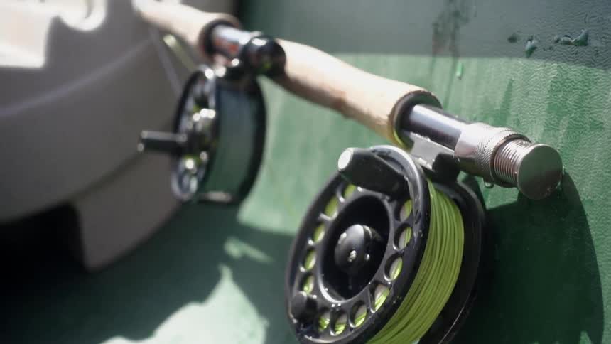 The fishing pole has two large reels in the boat