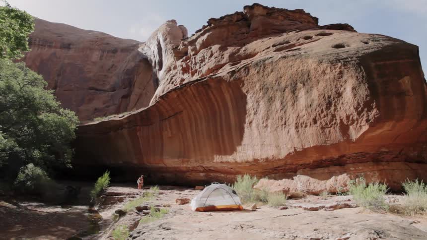 A person walks out from the canyons ahead