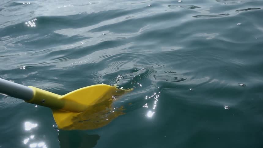 An oar moves through water