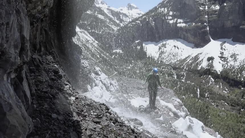 Hiker crosses near a waterfall