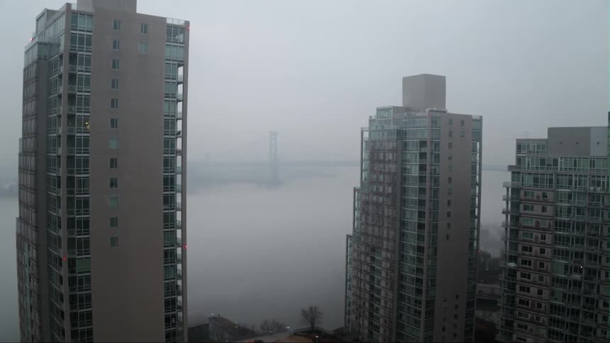 Fog hangs over the city harbor