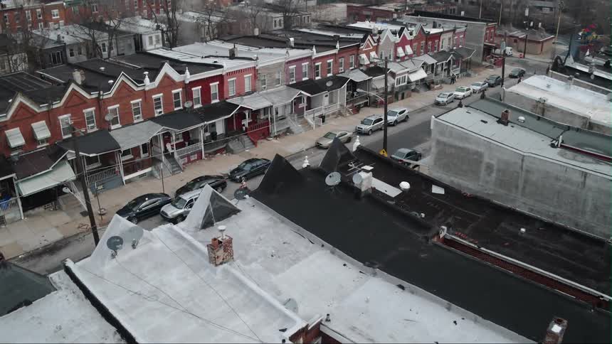Snow covers building rooftops in a city