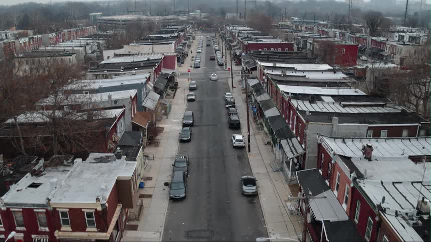 A car drives down the road of this town