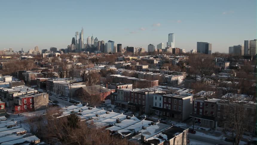 Buildings and skyscrapers and bare trees in city during winter