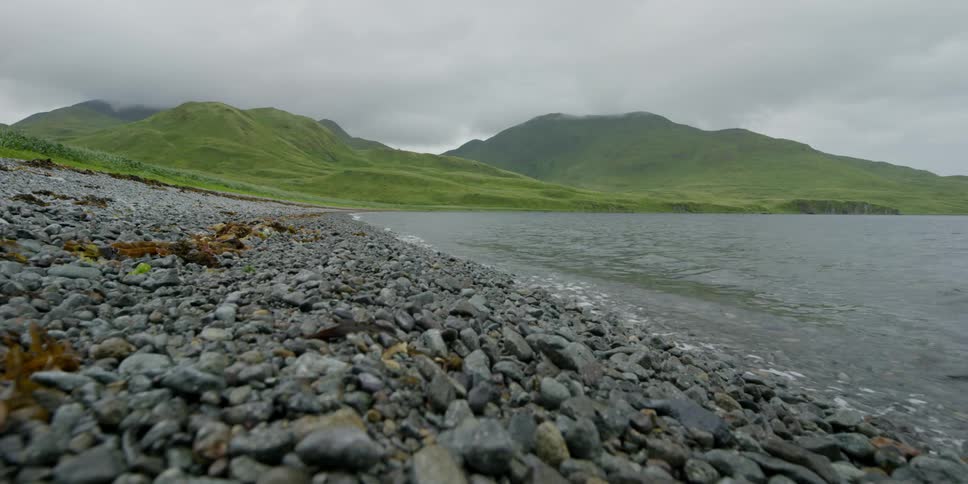 Ocean waves roll up on to a rocky shore
