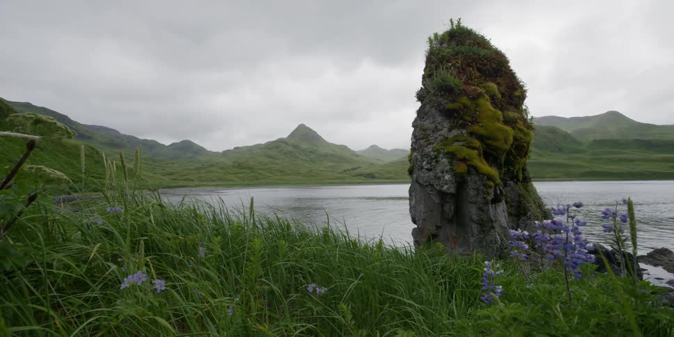 A rock formation sits next to a bay