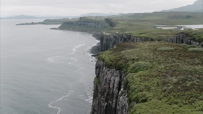 A rocky cliff borders the seashore