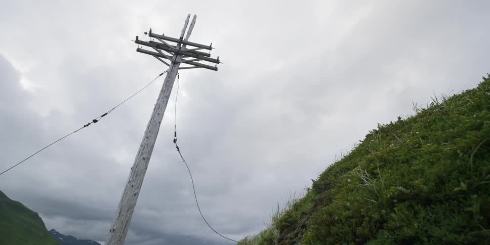 An old power line stands at an angle