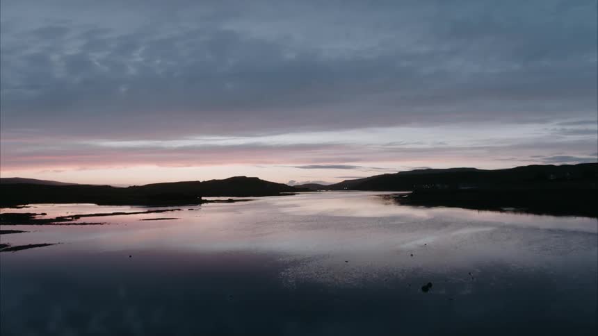 A sunset reflects on a lake