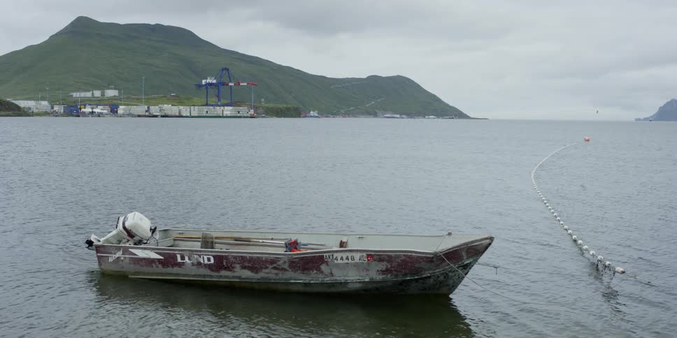 A boat is tied to a net in the ocean