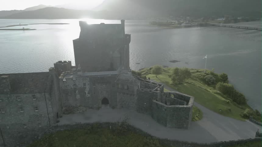 Old castle Eilean Donan sits on a hilltop overlooking a bay
