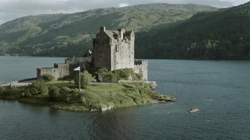 An old stone building sits on a lake island