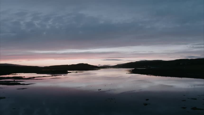 A sunset reflects on a lake
