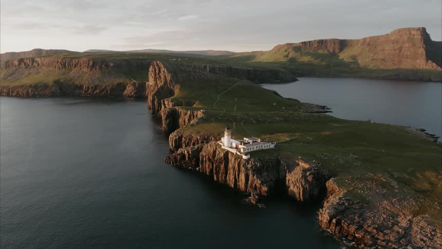 A lighthouse sits perched on a steep cliff