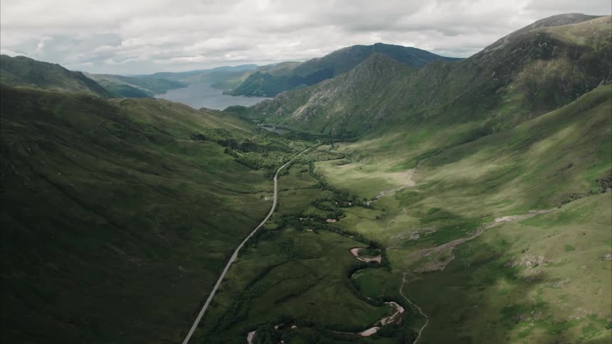 Clouds hover over a mountain valley