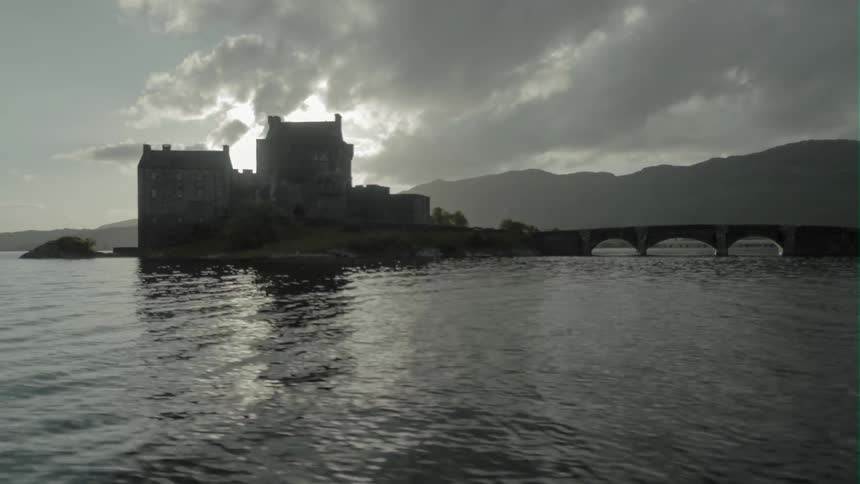 An old stone building sits on a lake island