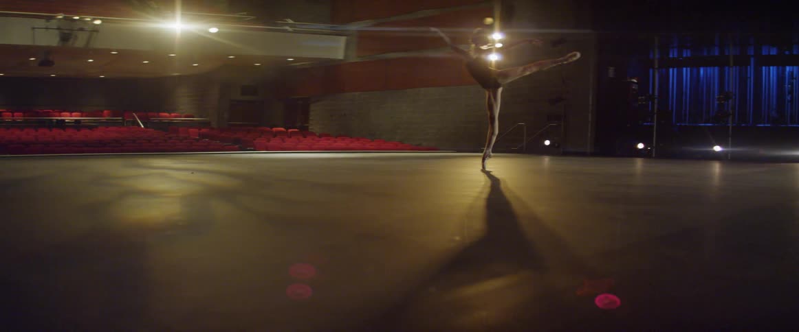 A ballerina dances on a stage