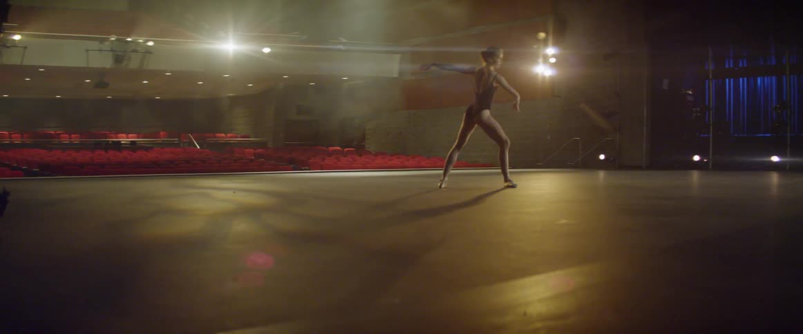 A ballerina dances on stage