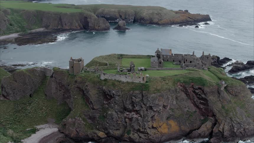 Stone walls and towers on top of an ocean side cliff