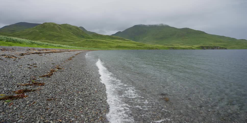 Ocean waves roll up on to a rocky shore