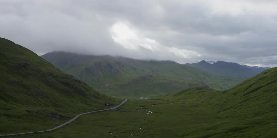 Time lapse of clouds dancing around a mountain peak