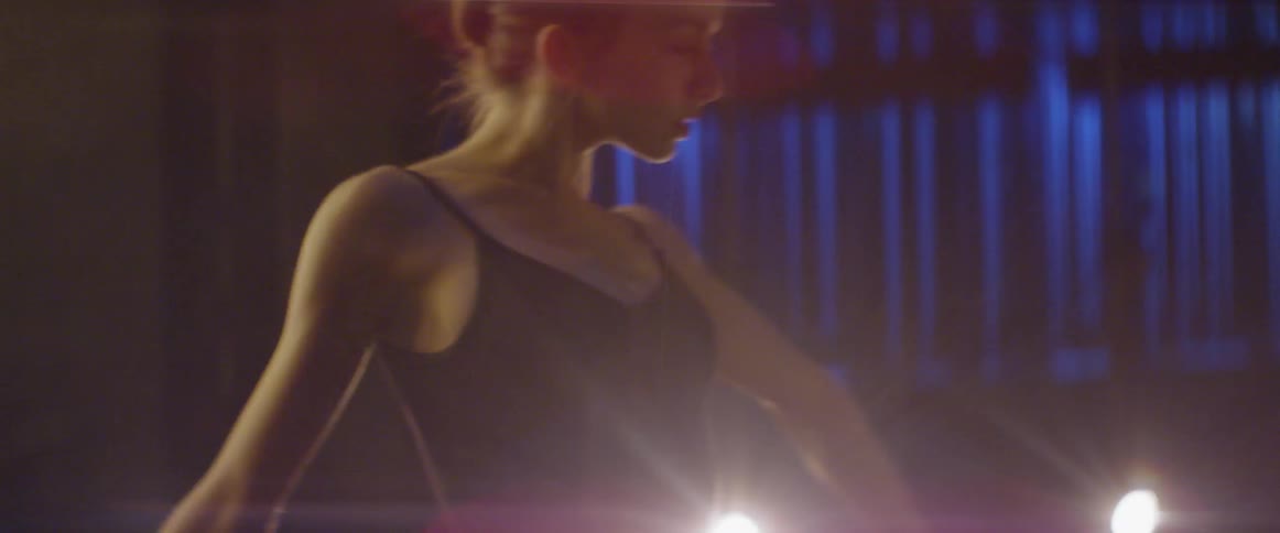 Woman practices dancing on an empty stage