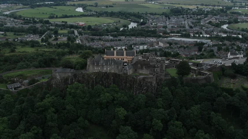 A castle sits perched on a hilltop
