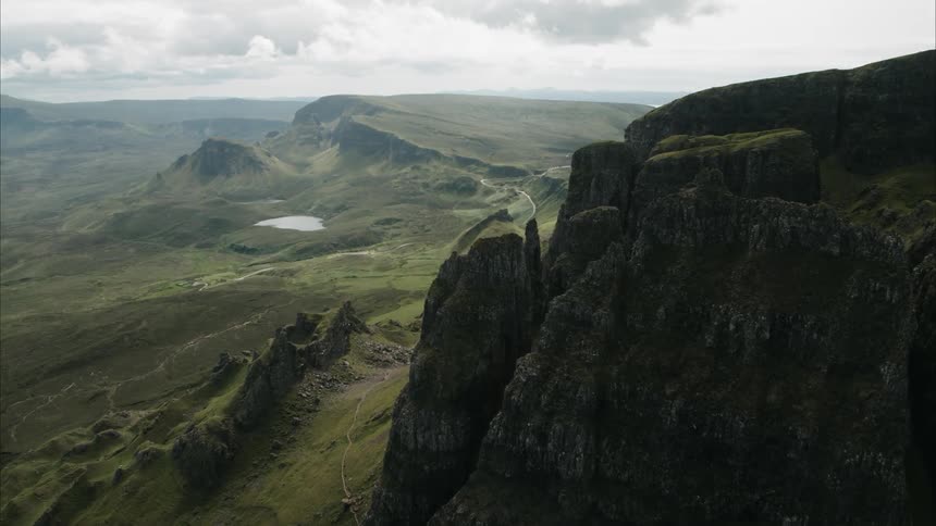 Mountains covered in green grass on cloudy day