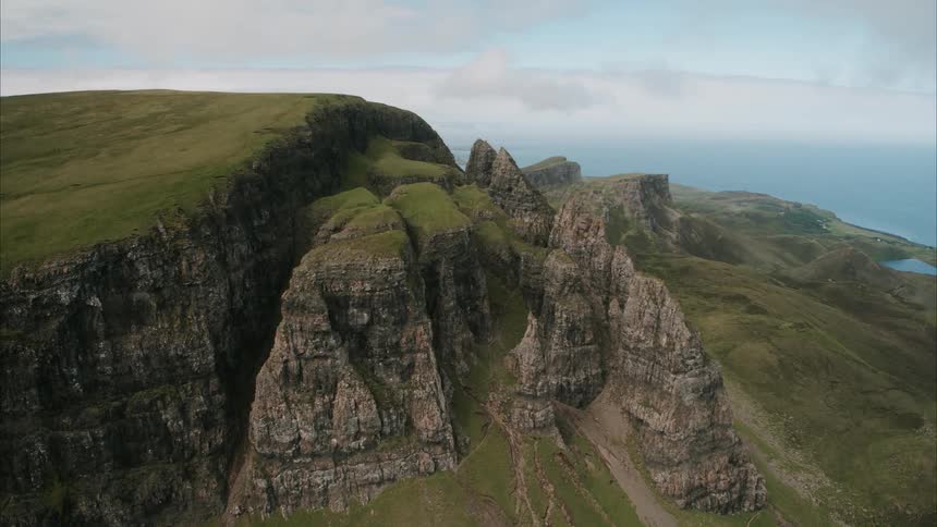 Green grass on top of cliffs and rock formations
