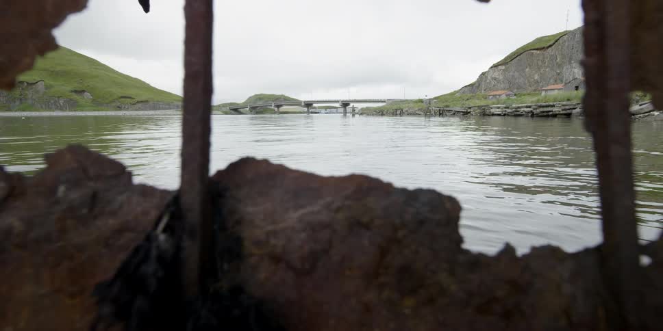 Water flows in a bay near rusty metal