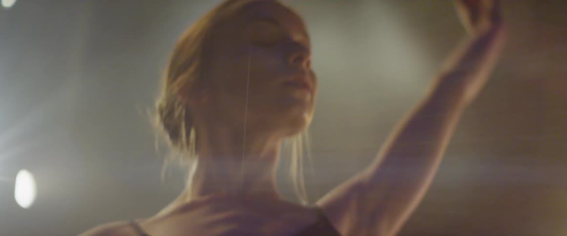 A ballerina twirls on stage