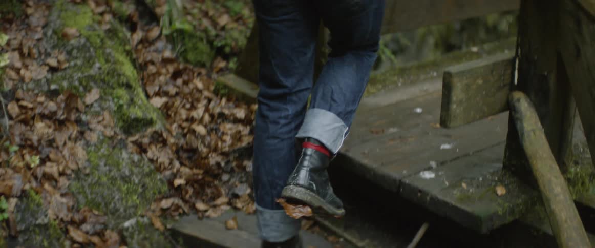 A hiker walks up wooden steps