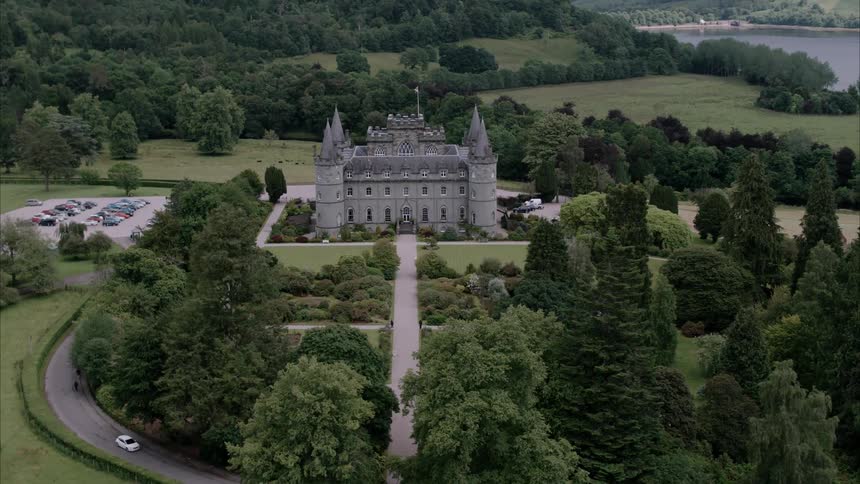 Vehicles drive by an old castle
