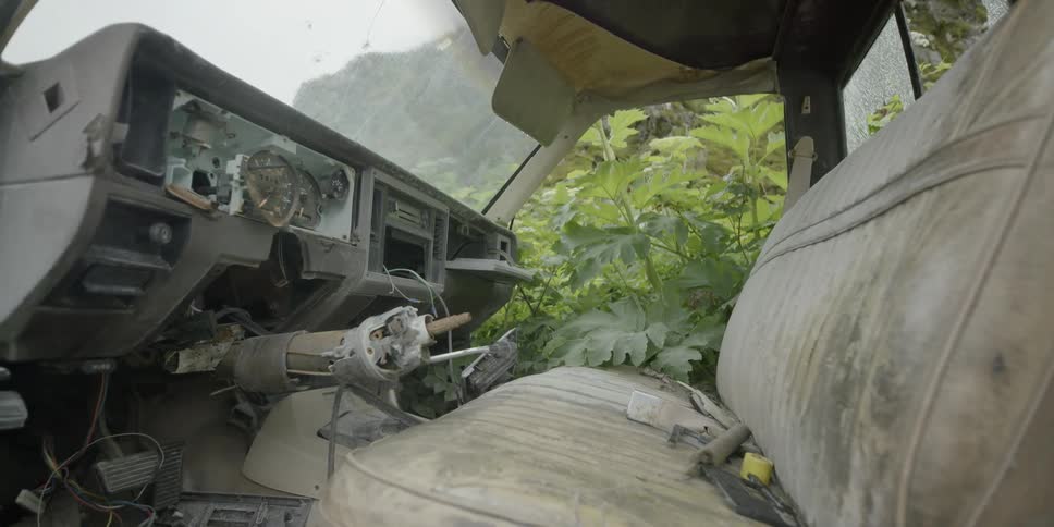 An old abandoned vehicle is covered with dust