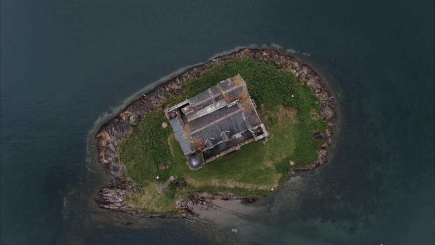 An abandoned castle on a small island surrounded by water