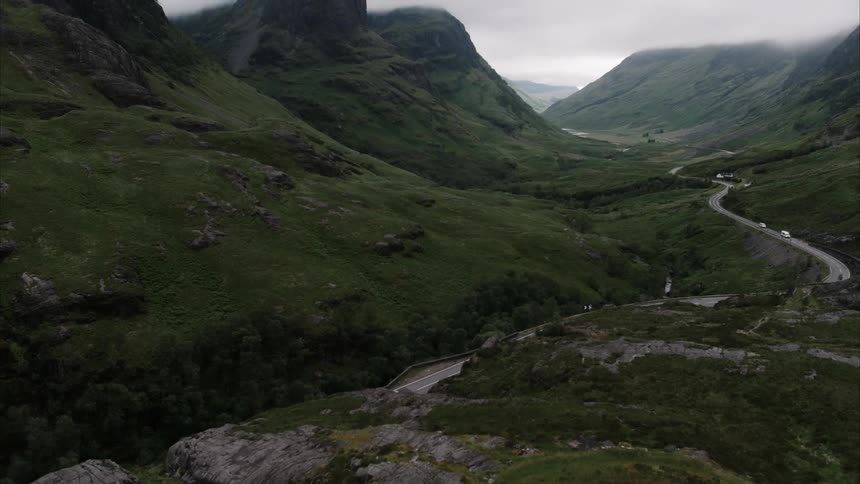 Cars drive on a mountain road