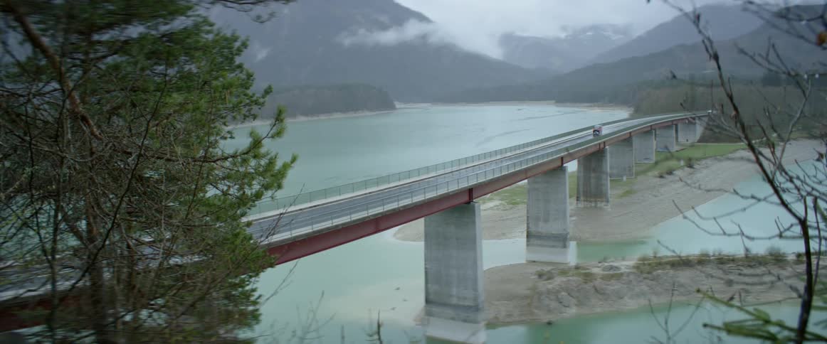 A truck drives across a bridge